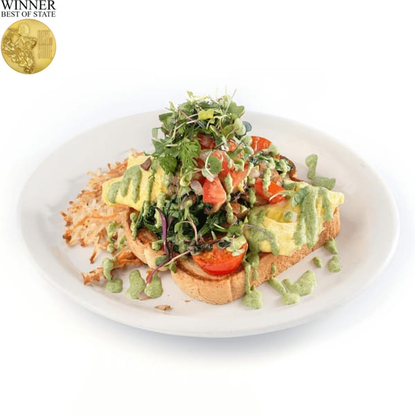 TRUreligion's breakfast plate with hash browns, toast, scrambled eggs, tomatoes, and green sauce.